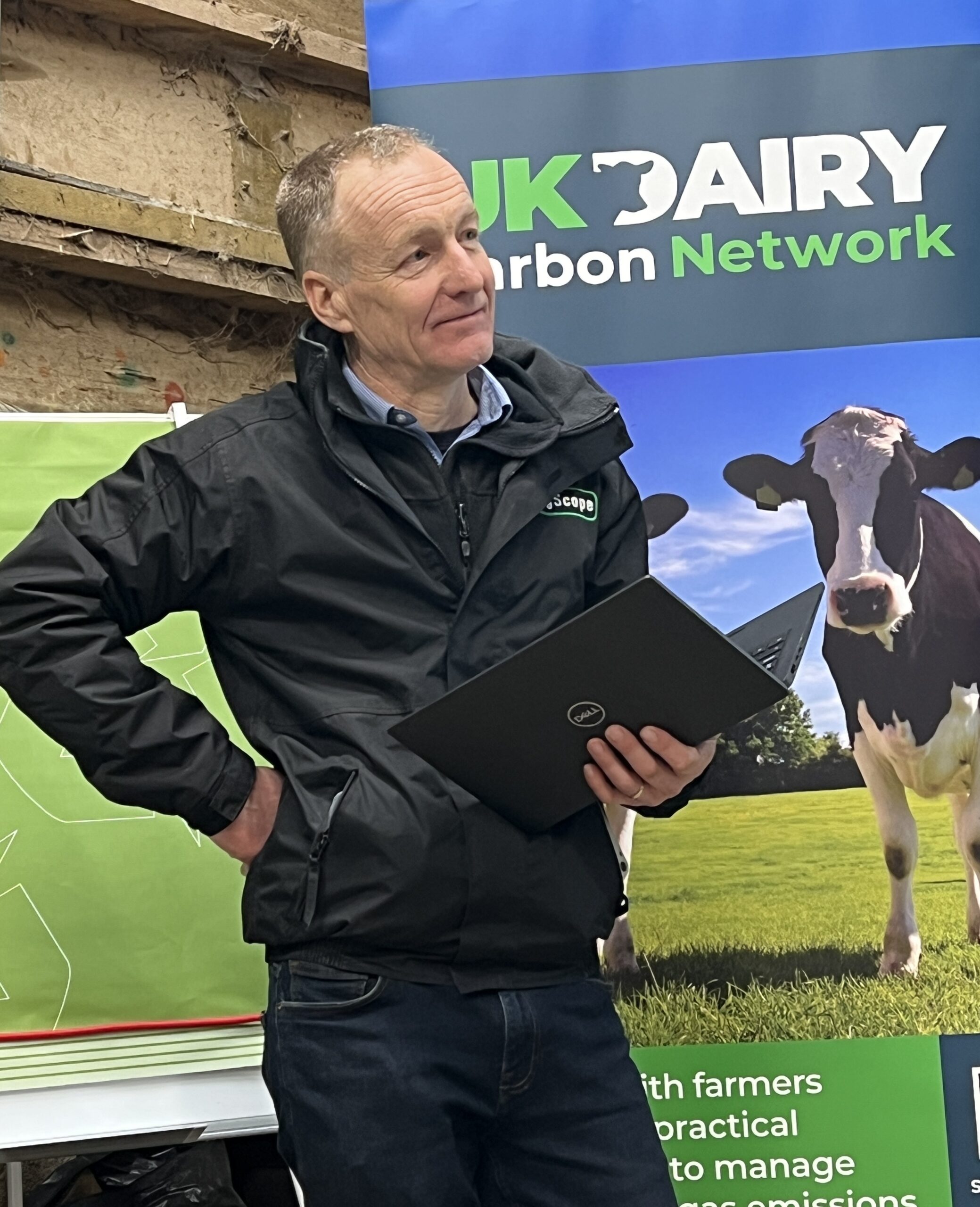 James Bretherton - speaker in front of Uk Dairy Carbon Network advertising banner